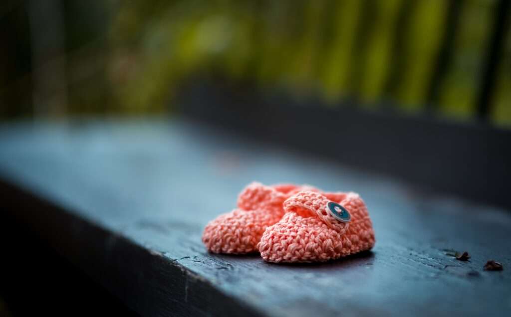 Baby shoes on a bench for fertility acupuncture